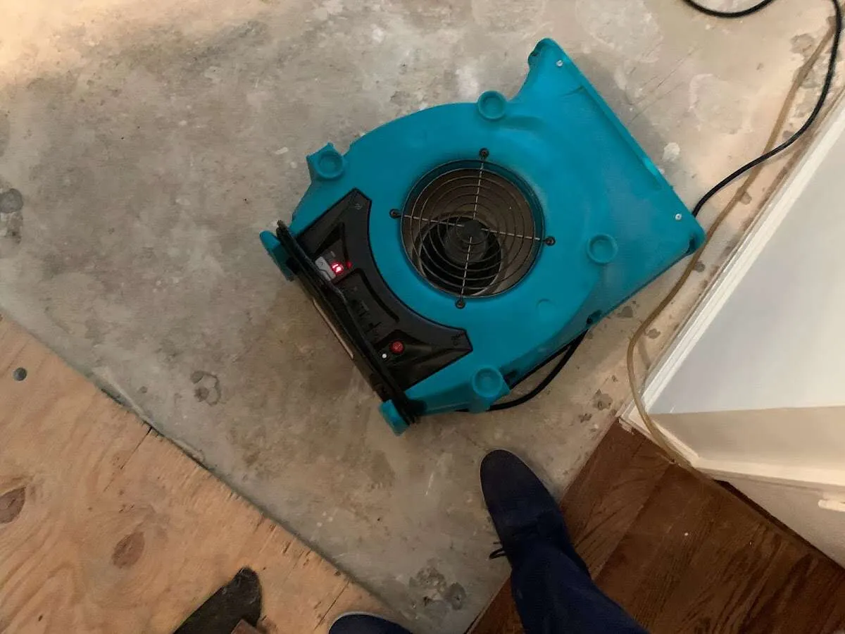 Air mover drying subfloor during Commercial Water Damage Restoration in Boxborough